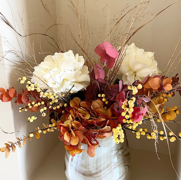 Vase filled with dried  and silk flowers